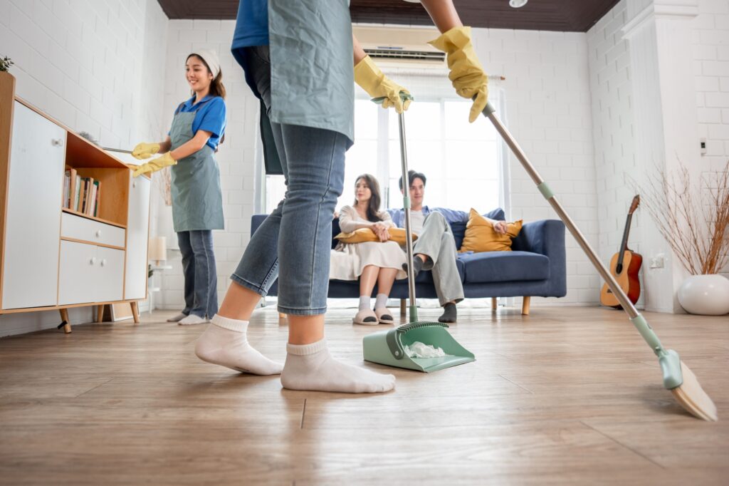 Asian cleaner team cleaning living room at home for new couple customer.