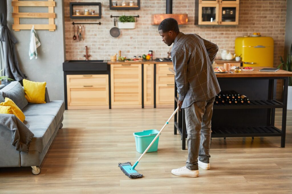Young Man Cleaning Floors at Home